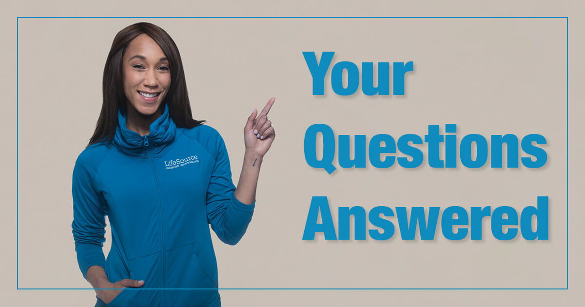 woman in lifesource sweatshirt pointing to words "Your Questions Answered"