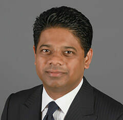 Sakpal Sujit wearing a black suit and tie