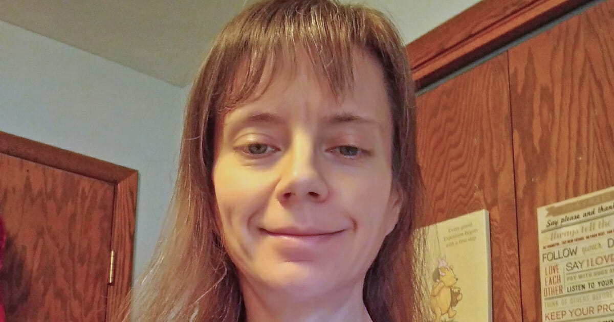 A woman with bangs smiling