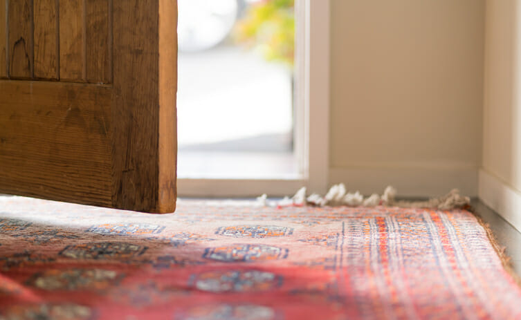 A wooden door opening to the outside