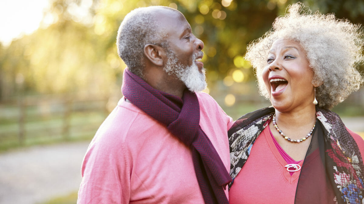 Senior Couple On Autumn Walk In Countryside Together