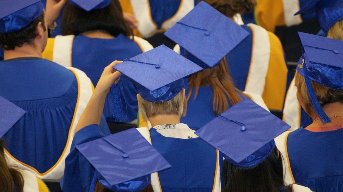 Students in cap and gown at graduation ceremony