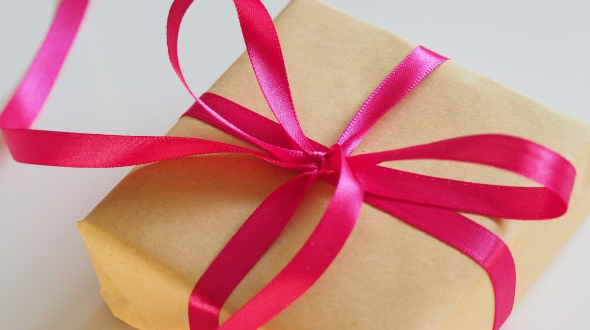 package with pink ribbon tied around it