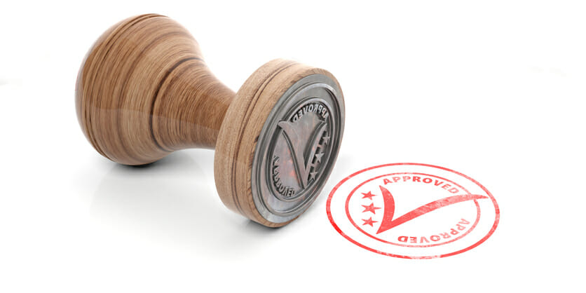 Rubber stamp of approval with checkmark