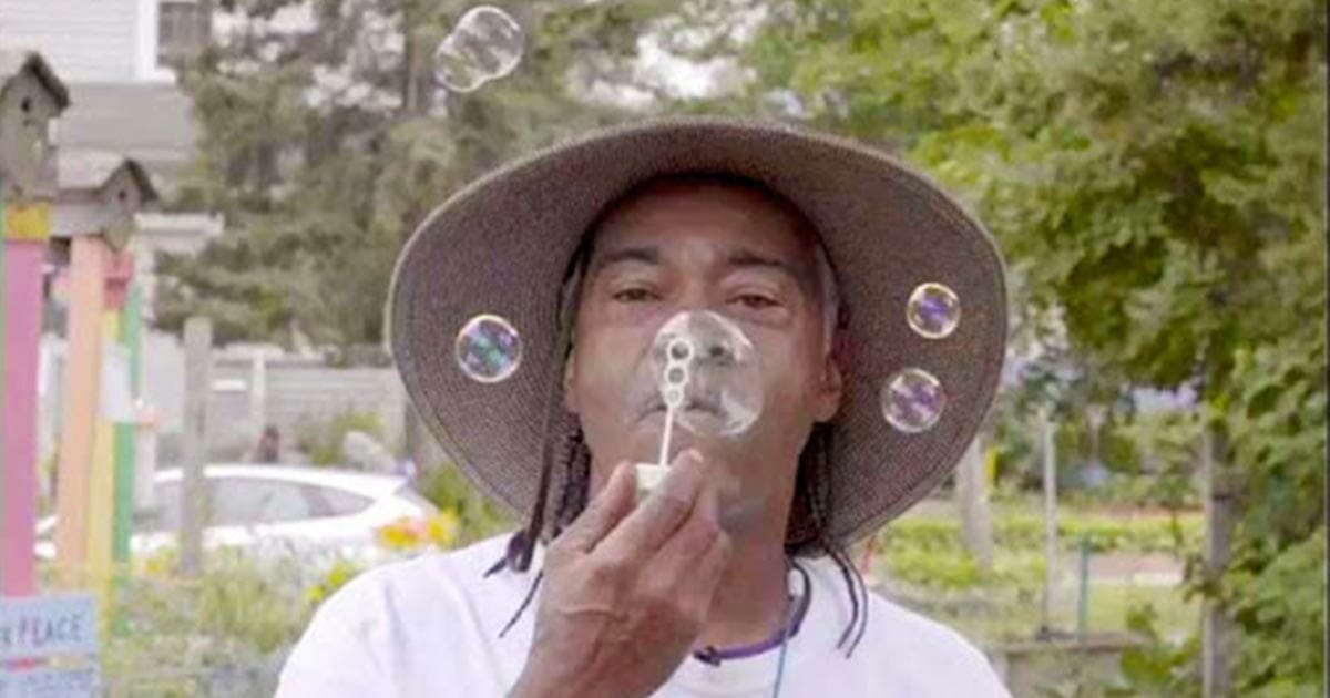 Melvin Giles blowing peace bubbles