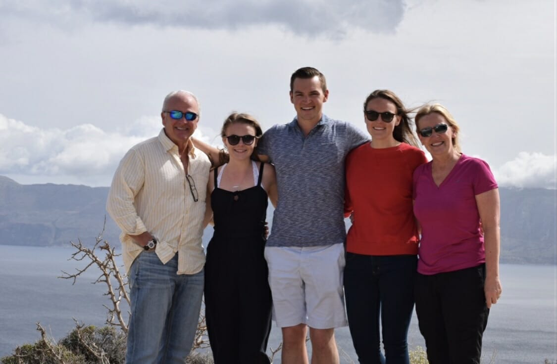 Parents and three children smile at camera