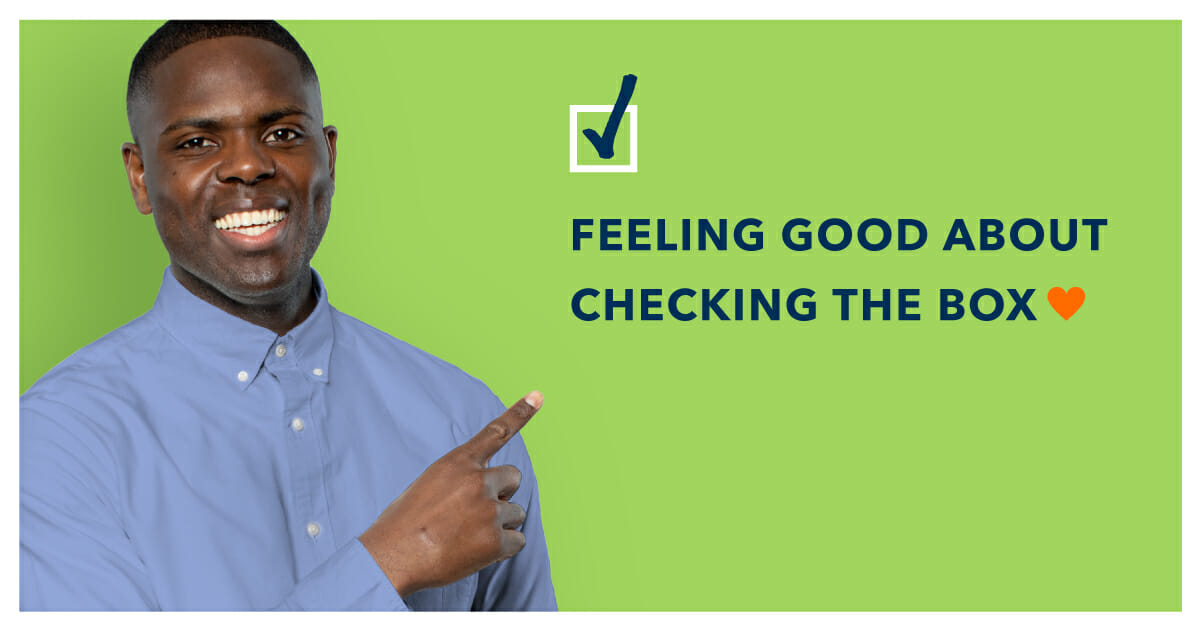 smiling man points to text: feeling good about checking the box