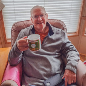 Dean Rogers holding a cup of coffee