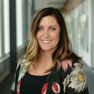 Woman in floral print shawl smiles at camera