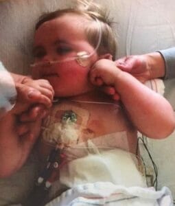 Jackson as an infant in hospital, surrounded by family