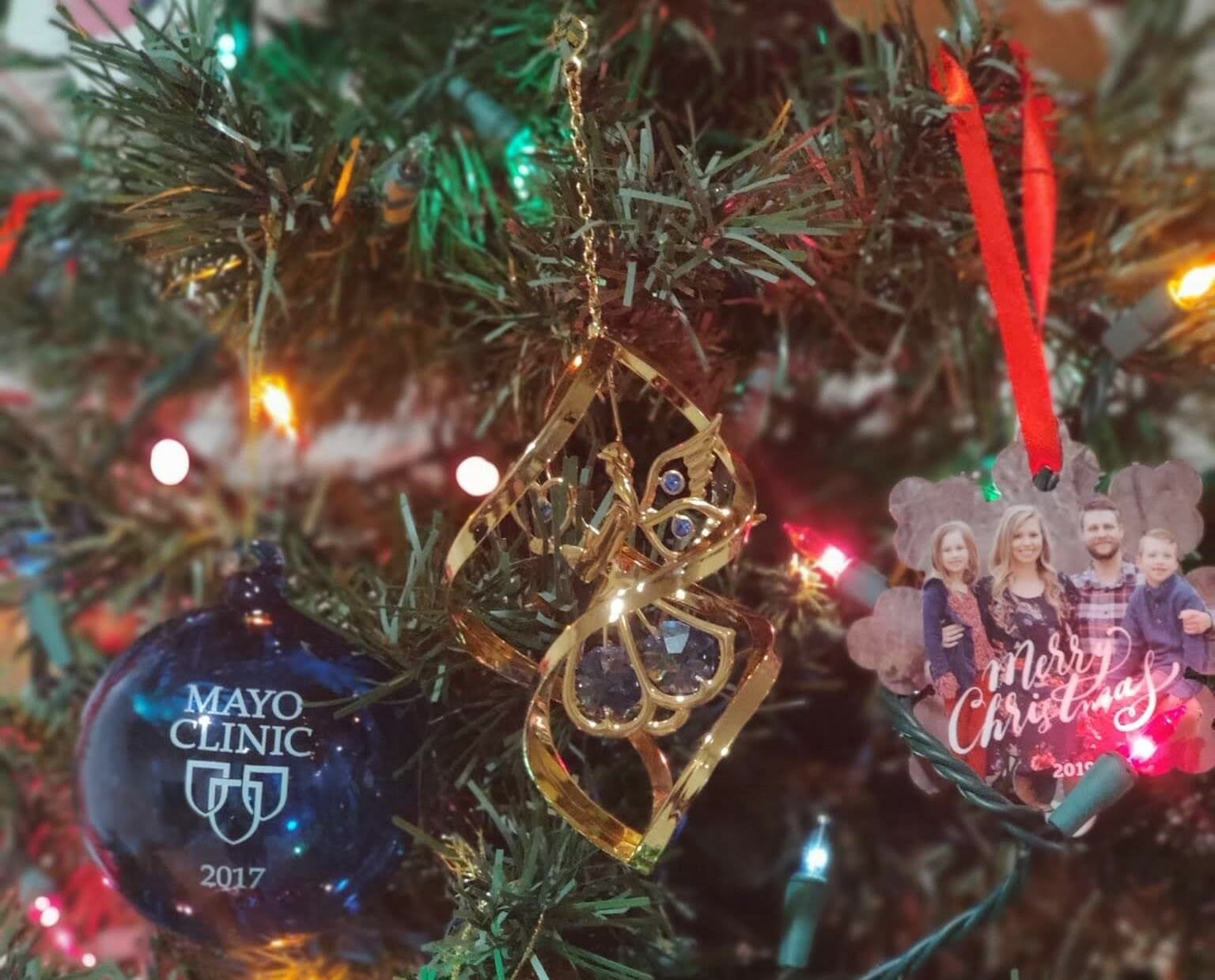 Gold angel ornament hangs on christmas tree