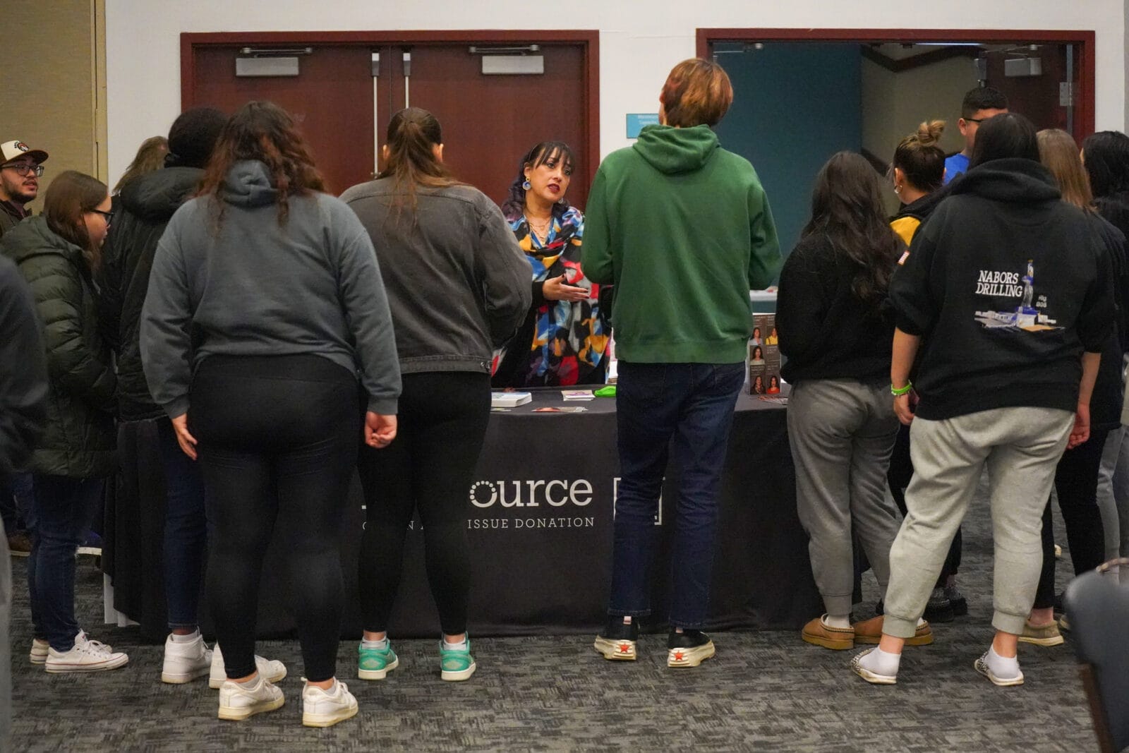 people stand around table learning about organ, eye and tissue donation.